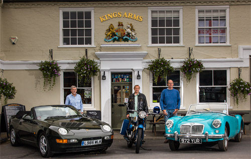 Organisers of the inaugural Reepham Festival of Classic Cars and Bikes outside the King's Arms in Market Place, Reepham: Peter Fitzjohn (left) and Michael Pender-Cudlip (right), with an enthusiastic member of the BSA Owners Club. Photo: John Tym