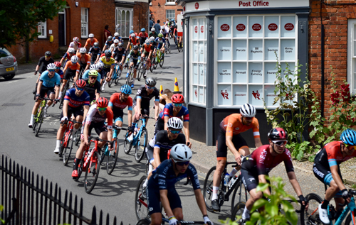The men's peloton in the HSBC UK National Road Championships racing down Church Hill from Reepham's Market Place. Photo: Charles Butcher