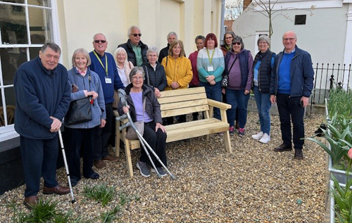 Reepham Lions president Kevin Long (right) and other members presented the bench to the chair of trustees for the Bircham Centre, Les West (third from left), along with other members of the Bircham Centre team. Photo: Reepham Lions