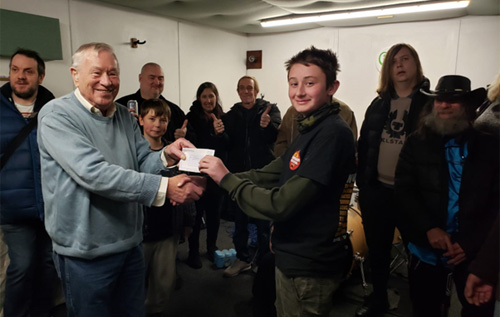 A representative from Reepham Festival presents a cheque for '£1,000 to the Black Dog Music Project. Photo: Reepham Festival