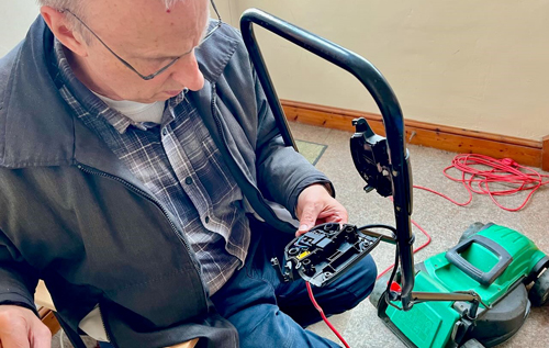 Fixer David Newton repairs an electric mower at The Fixery's session on Saturday 25 May. Photo: The Fixery