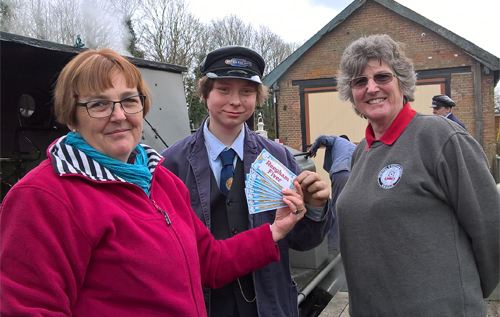 Left to right: Reepham Chamber of Commerce treasurer Claudia Lowe presenting the Reepham Fivers to Ben Sharred and fellow Whitwell Station volunteer Nanette Parfitt