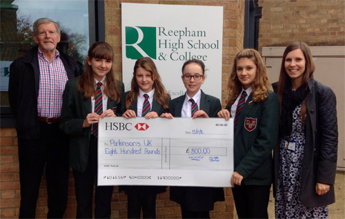 Left to right: Peter Fitzjohn of Reepham Festival, students Alicia Knights, Josie Barker, Suki Martinez and Erica Walters, and Amy Boag, head of Key Stage 3, Reepham High School & College, with the cheque for '£800 for Parkinson's UK