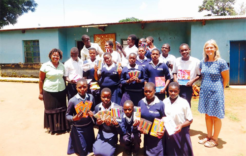 Reepham High School & College history teacher Karen Reynolds (right) with some of the staff and students of the Mchisu School in the Dedza region of Malawi showing stationery donated by RHSC students