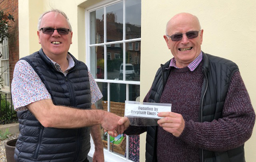 Barry Howes, president, Reepham Lions (right), presenting the plaques for the benches to Les West, chair, Bircham Centre trustees. Photo: Bircham Centre