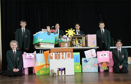 Year 7 pupils at Reepham High School with a selection of the harvest boxes designed and created by tutor groups from Years 7, 8 and 9. The overall winning harvest box was from tutor group 7CLN featuring a red flying tractor