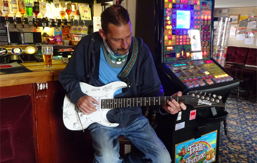 Mark Kovacevic with the Ibanez guitar donated by Reepham Life