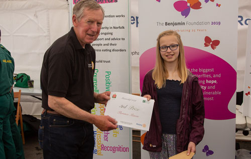 Reepham High School student Florence Mason receiving her third prize in the Junior Masterchef competition from Reepham & District Rotary Club president Steve Griggs. Photos: John Tym