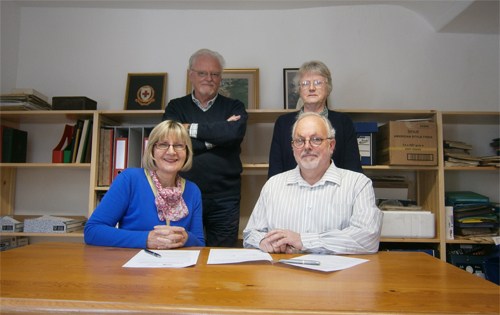 Seated (left to right) are Sue Ivins, chair of the trustees of the Bircham Centre, and Mike Cowdrey chairman of the Reepham Society. Standing (left to right) are archivists Chris Peakome and Jan Henry