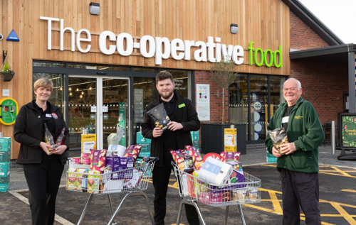 Store manager Brad Tuckfield (centre) donated two trolleys worth of food and essentials to Cromer & District Food Bank to mark the opening of the new Reepham Co-op store. Photo: Central England Co-operative