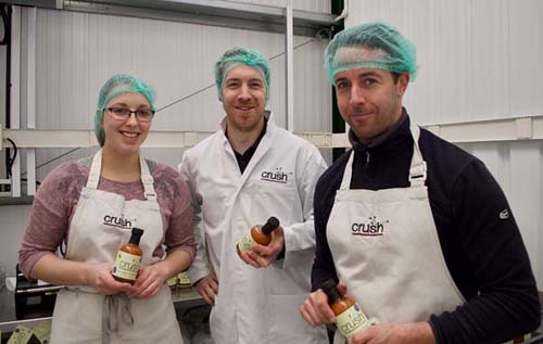 Left to right: production manager Amy Bekooy, Stephen Newham and Glenn Brown with bottles of Crush Foods' soy, ginger and chilli dressing