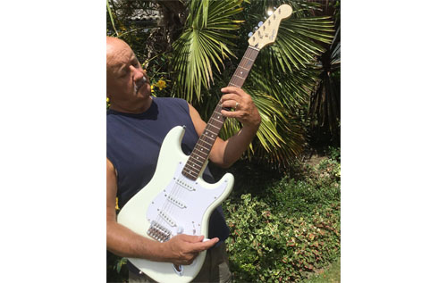 Festival director Steve Jenkins tries out the guitar sponsored by Reepham Life