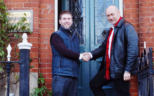 Tom Thornley (left), a director of The Original Cottage Company, and Alec Moss, managing director of Business Web Page, pictured outside Carlton House, having just signed the tenancy agreement