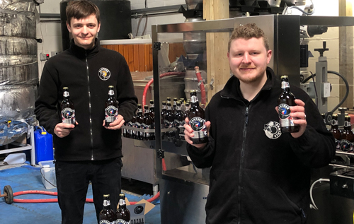Panther Brewery's Paul Ashmore, assistant brewer (right), and Aaron Bartrum, apprentice brewer, with the newly launched Platinum Jubilee Pale Ale. Photo: Panther Brewery